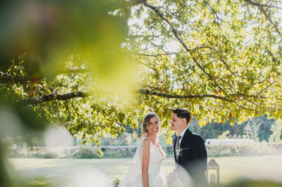 Cheerful couple standing at park