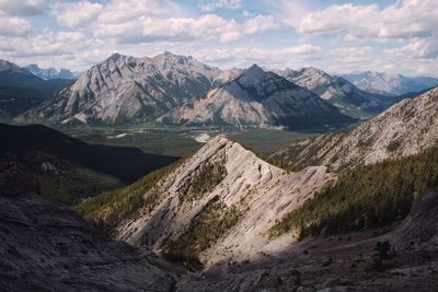 Scenic view of mountain peaks against cloudy sky