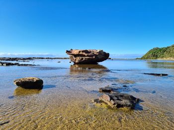 Scenic view of sea against clear blue sky