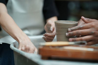 Midsection of man working at workshop