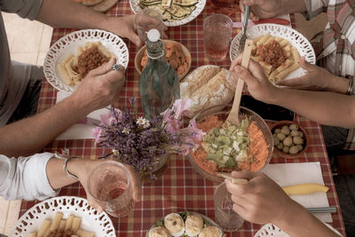 High angle view of people holding ice cream on table