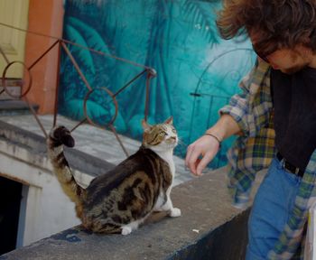 Full length of man with cat