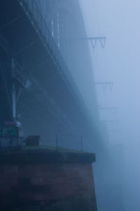 Low angle view of bridge against sky in city
