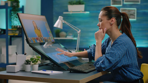 Young woman using laptop on table