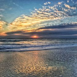 Scenic view of beach against sky during sunset