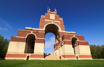 Low angle view of historical building against clear blue sky