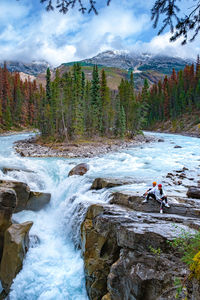 Scenic view of waterfall against sky