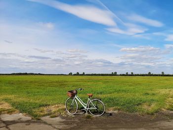 Bicycle on field against sky