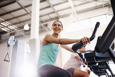 Side view of woman exercising in gym