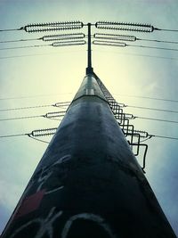 Low angle view of power lines against sky