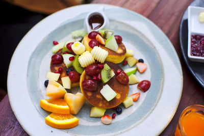 High angle view of fruits in plate on table