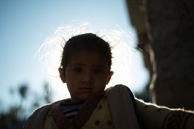 Portrait of cute girl against sky