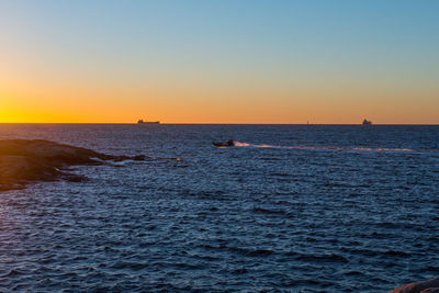 Scenic view of sea against clear sky during sunset