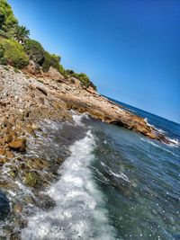 Scenic view of sea against clear blue sky