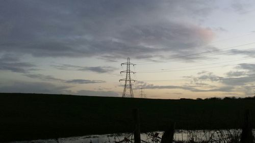 Low angle view of electricity pylon against sky