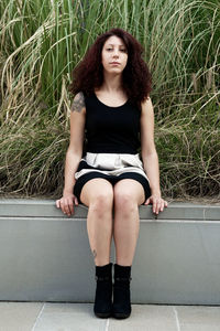 Portrait of a young woman sitting outdoors