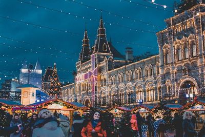 View of illuminated city against blue sky