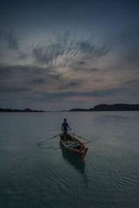 Boat in sea at sunset