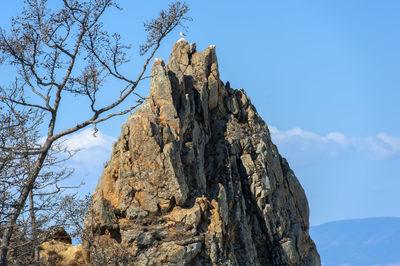 Low angle view of rock formation against sky