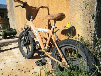 Bicycle parked against building