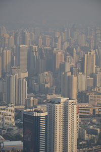 Aerial view of buildings in city against sky