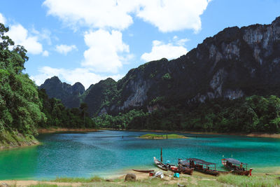 Scenic view of sea and mountains against sky