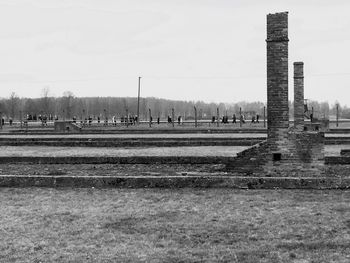 Built structure on field against sky