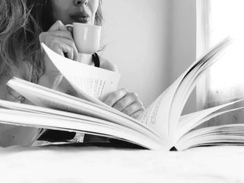 Midsection of woman with coffee cup