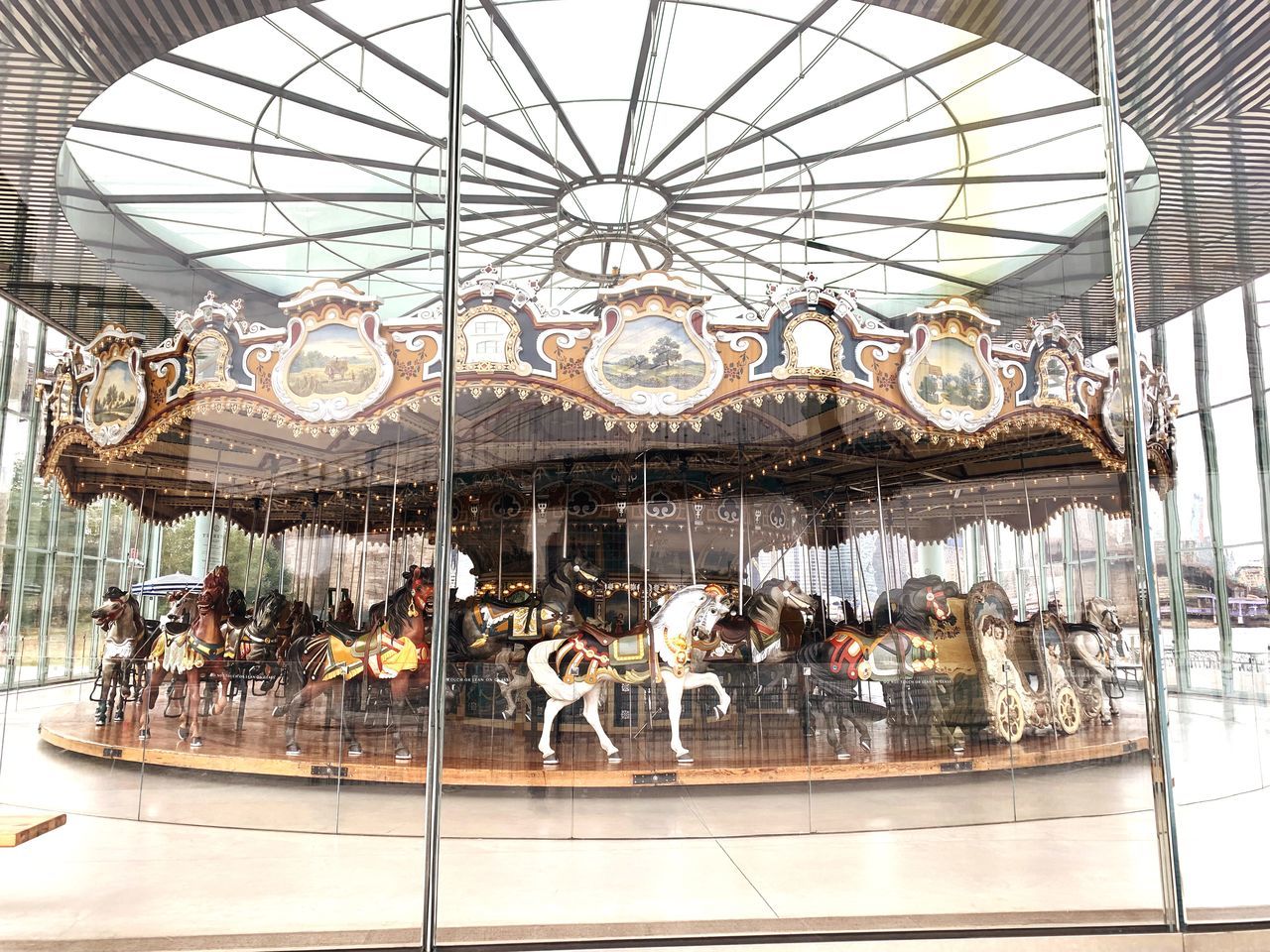 arts culture and entertainment, carousel, amusement park, animal representation, amusement park ride, representation, carousel horses, day, architecture, no people, outdoors, built structure, animal wildlife, leisure activity, animal, mammal, art and craft, ceiling, merry-go-round