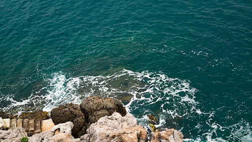 High angle view of rocks on sea