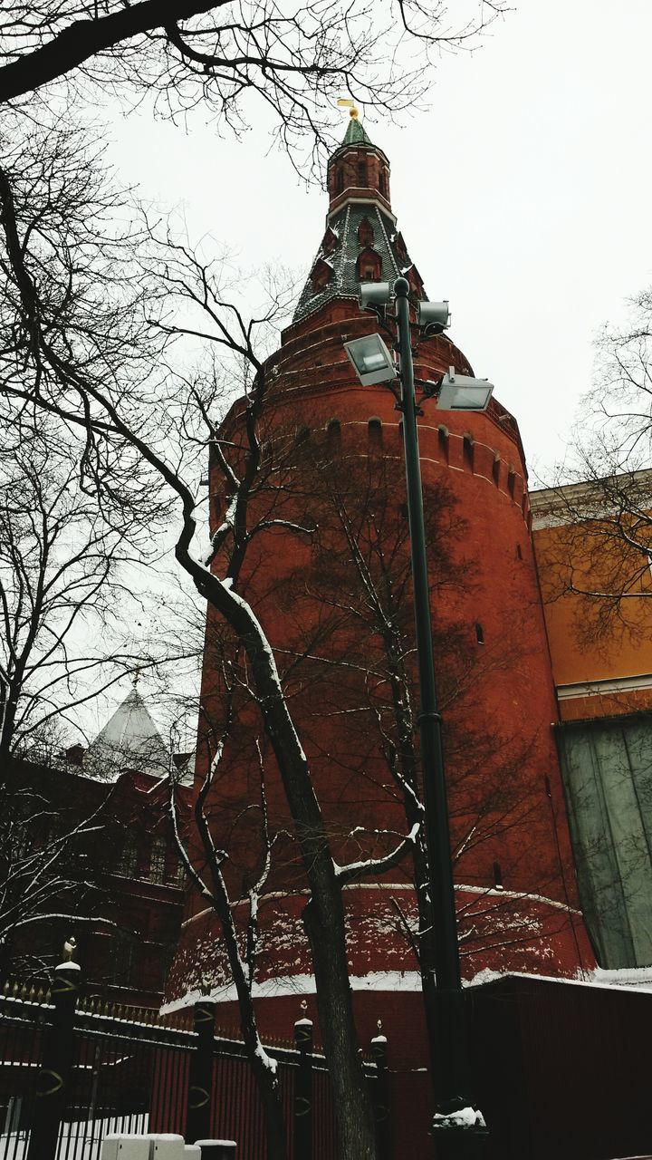 architecture, built structure, building exterior, low angle view, tower, tall - high, tree, sky, city, clear sky, bare tree, architectural feature, day, travel destinations, outdoors, no people, branch, famous place, tall, building