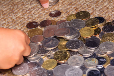 Cropped hand of person holding coins