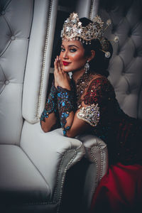 Portrait of a young woman sitting outdoors