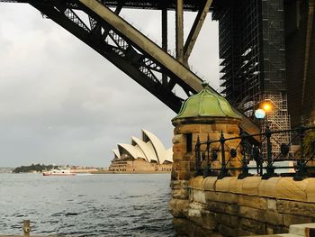 Bridge over sea against buildings in city