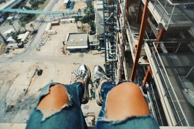 Low section of man standing on cable car