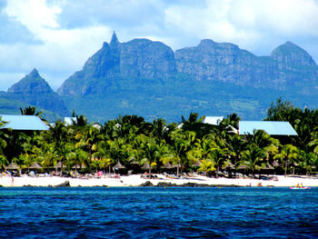 Scenic view of sea and mountains against sky