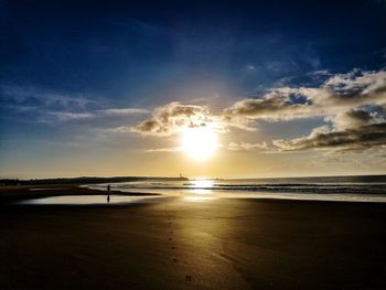 Scenic view of beach against sky during sunset