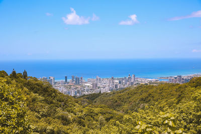 Scenic view of sea and buildings against sky