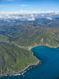 High angle view of sea and mountains against sky