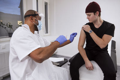 Young man getting vaccinated against covid-19
