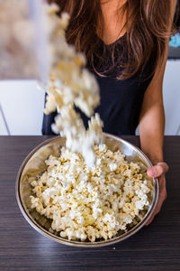 Midsection of man preparing food in bowl