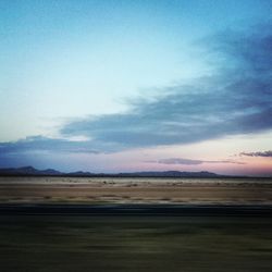 Scenic view of mountains against cloudy sky