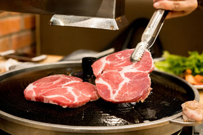Close-up of meat cooking in kitchen