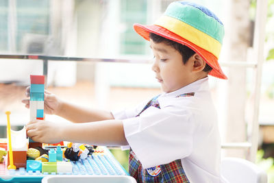 Side view of boy looking at camera