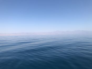 Scenic view of sea against clear blue sky