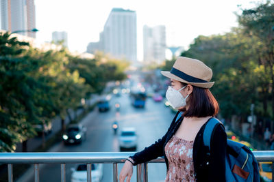 Woman wearing mask while standing in city
