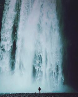 Scenic view of waterfall against sky