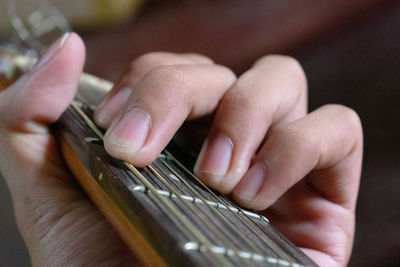 Midsection of person playing guitar