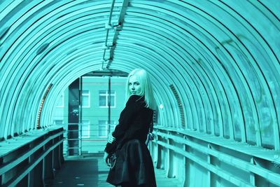 Young woman standing on covered walkway