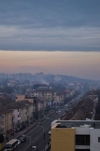 Cityscape against cloudy sky